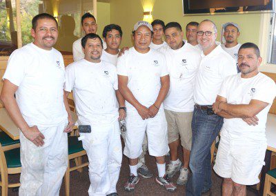 A Group of Men Sitting in White Color Shirts Posing