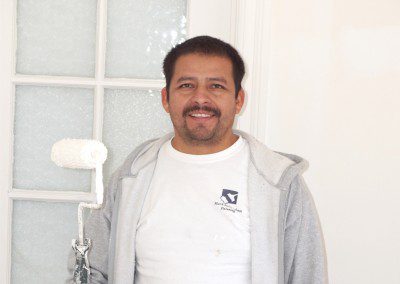 A Man in a White Color Shirt With a Navy Color Logo