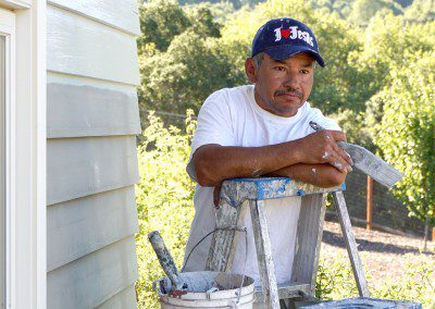 A Man in a White Color Polo Shirt on a Ladder