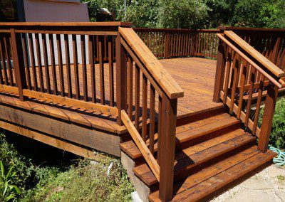 A Finished Wooden Deck With a Railing